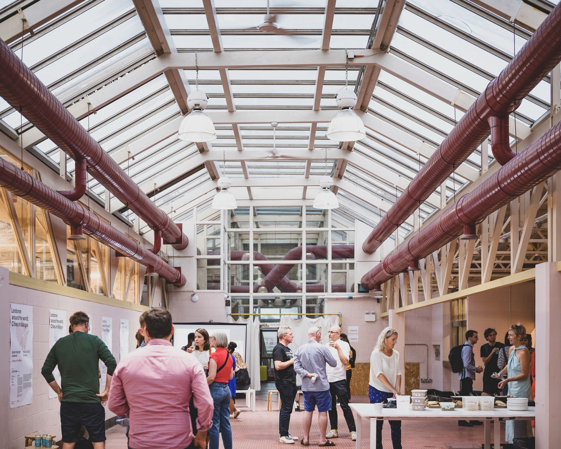 An event in the Main Hall of Hackney Depot, under the glazed roof with red ductwork